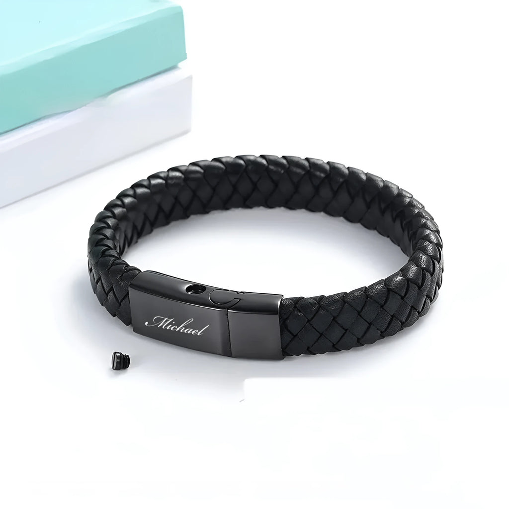 Black stainless steel memorial bracelet with woven leather detailing, showing personalisation engraving area.