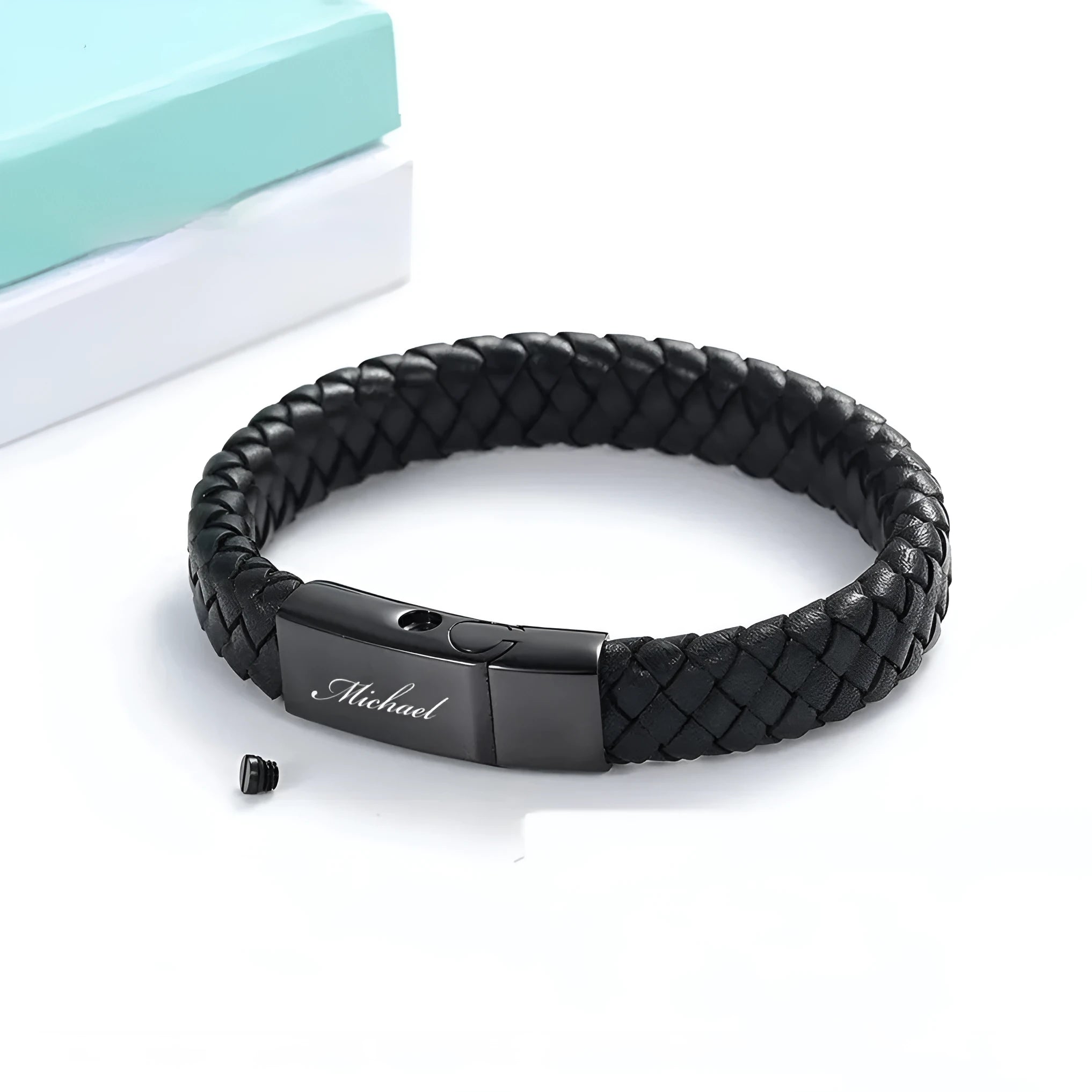 Black stainless steel memorial bracelet with woven leather detailing, showing personalisation engraving area.