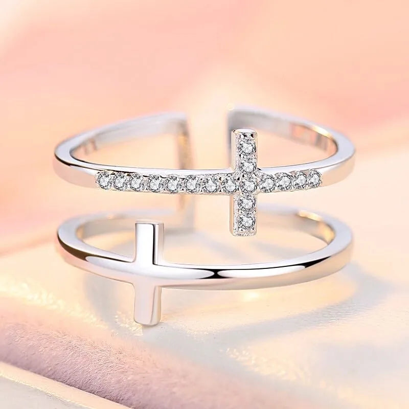 Adjustable double cross geometric ring in copper with cubic zirconia stones, shown in a gold colour finish.