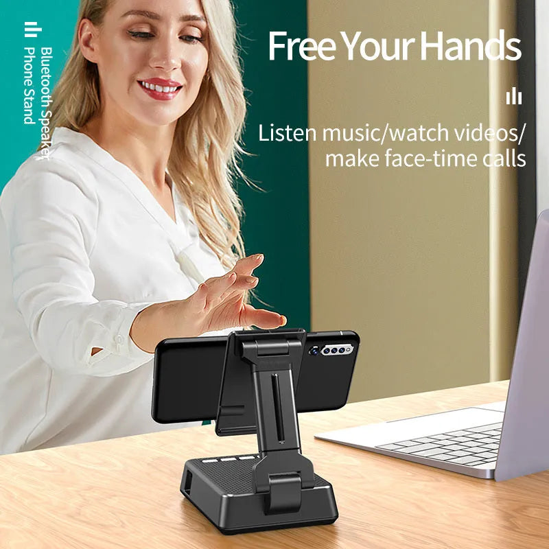 Black mobile phone broadcaster stand with Bluetooth speaker and microphone on a desk