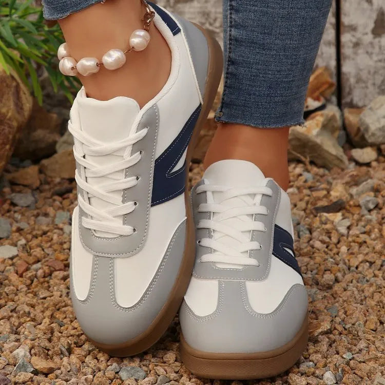 Women's blue flat German training hiking shoes with rubber sole and artificial PU upper, low-top lace-up style on neutral background