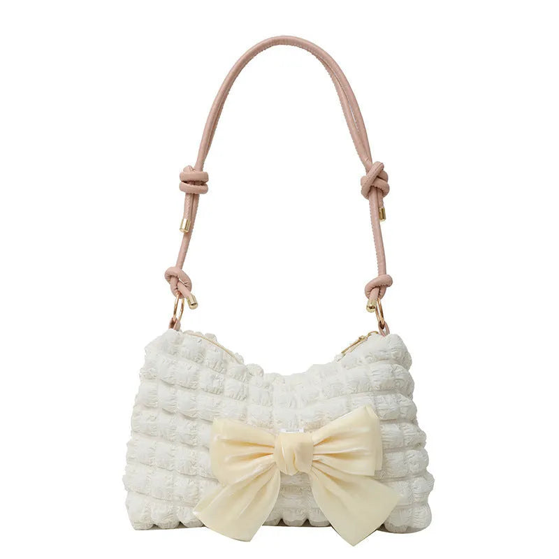 Women's one-shoulder canvas handbag in horizontal square shape with single strap.