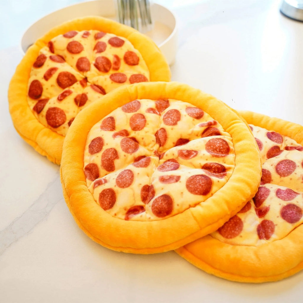 Yellow pizza slice dog chew toy with squeaker and dental grinding surfaces