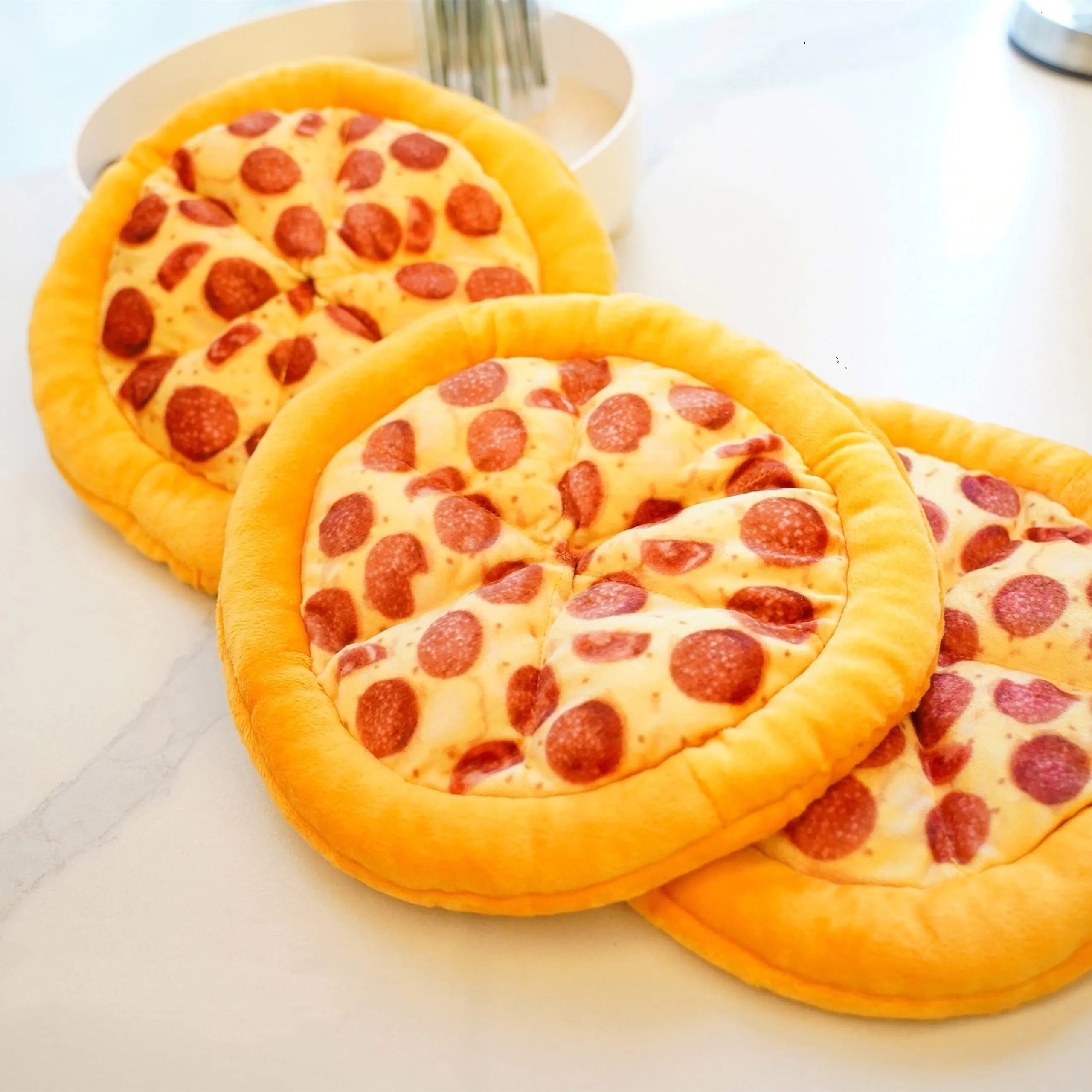 Yellow pizza slice dog chew toy with squeaker and dental grinding surfaces