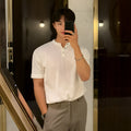 Man wearing a black thin slim-fit ice silk knitted short-sleeved bottoming shirt.