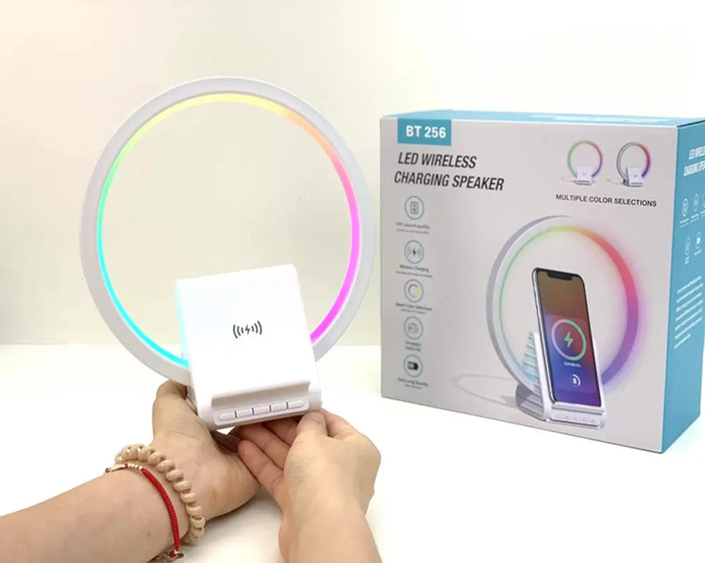 White smart Bluetooth speaker with integrated ambient light and 15W wireless charging pad on top.