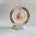 Magnetic levitation heart night light with pink eternal rose floating inside transparent sphere on triangular stand