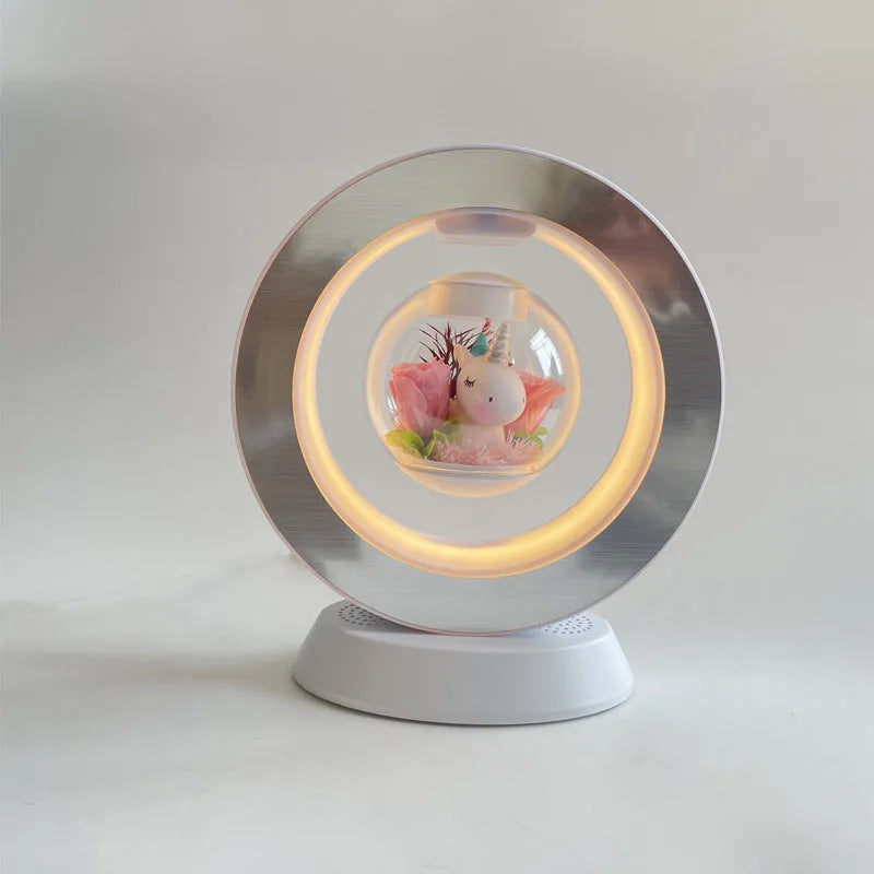 Magnetic levitation heart night light with pink eternal rose floating inside transparent sphere on triangular stand