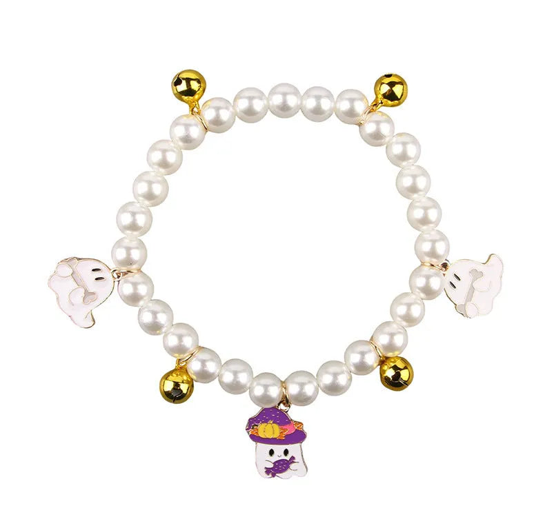 Halloween cat collar with simulated pearl necklace and a central pumpkin charm decoration.