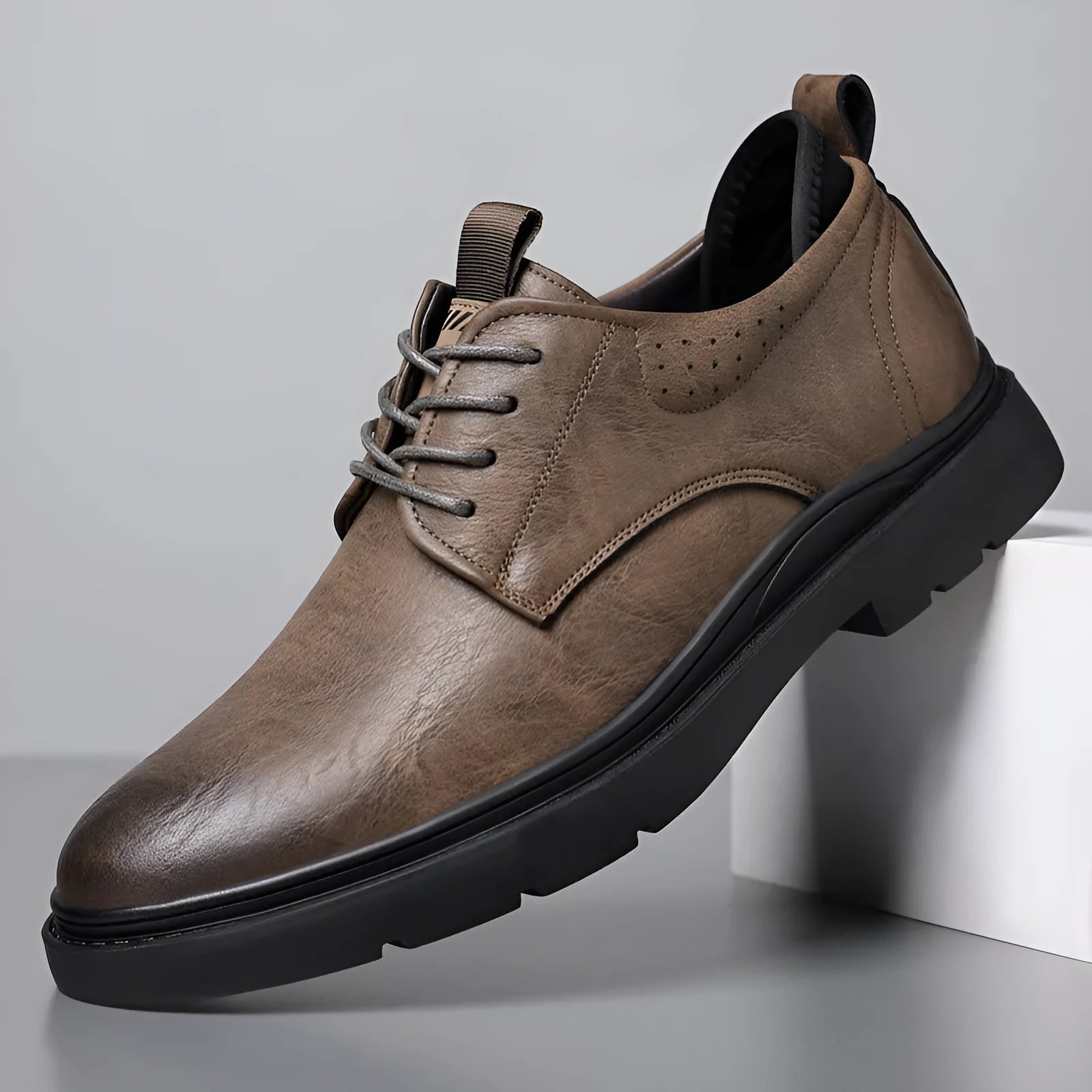 Men's black and brown leather casual sneakers with rubber sole and sewing line detailing