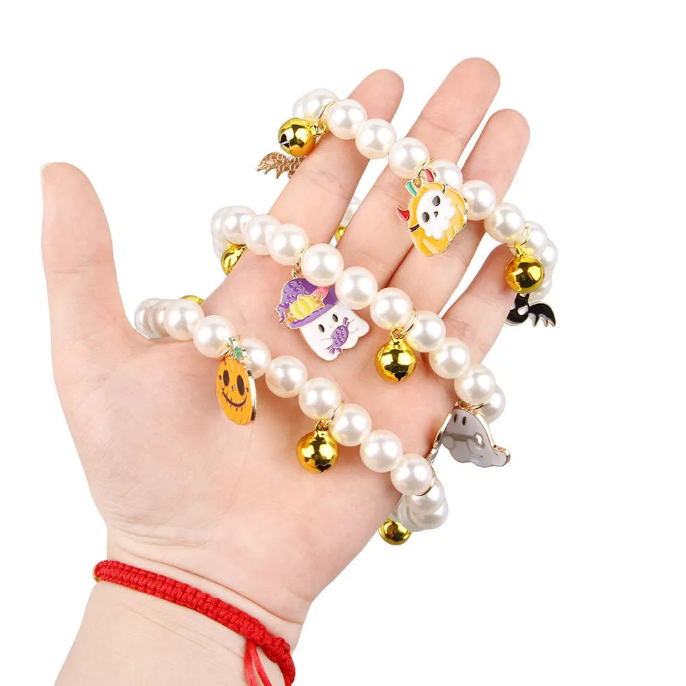 Halloween cat collar with simulated pearl necklace and a central pumpkin charm decoration.
