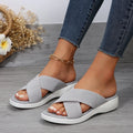 Women's black peep-toe wedge slippers with a thick rubber sole and fish mouth design on a white background.