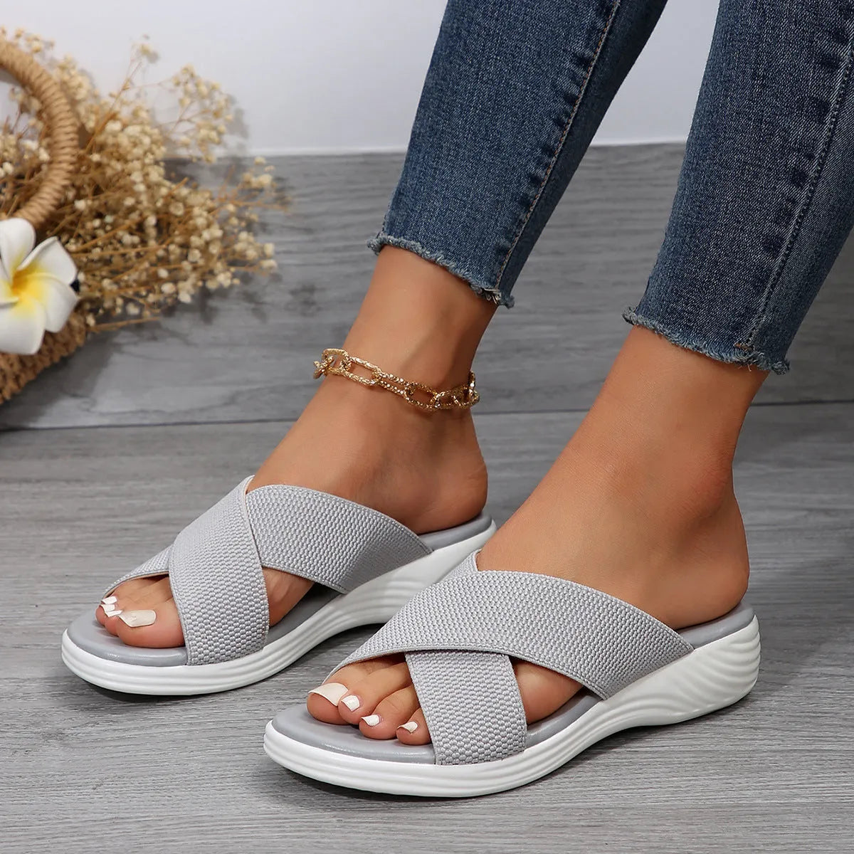 Women's black peep-toe wedge slippers with a thick rubber sole and fish mouth design on a white background.
