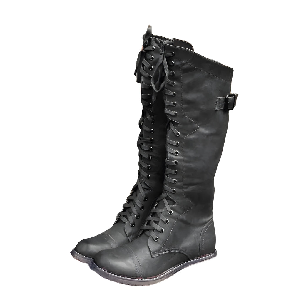 Women's black knight-style ankle boots with a cross-strap design across the front.