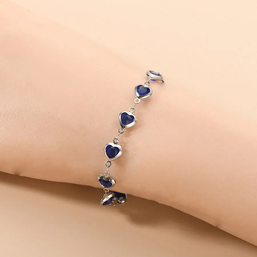 Devil's Eye Creative stainless steel heart bracelet in one of six electroplated colours on a wrist.