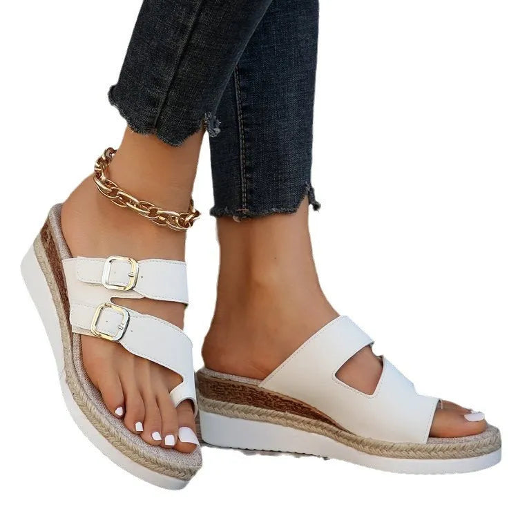 White wedge heel sandals with woven patent leather upper and peep toe design