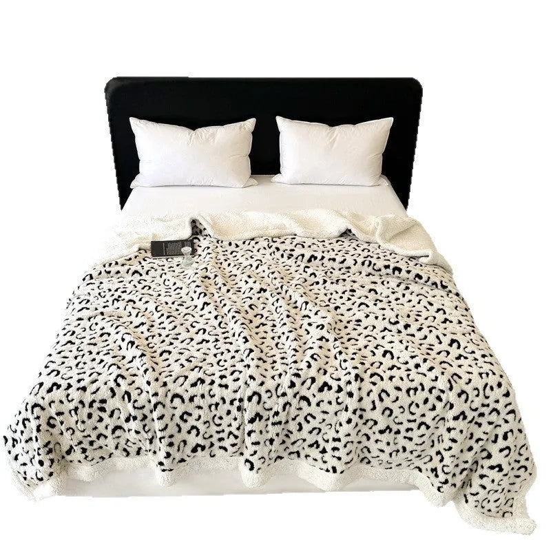 Double-layer cationic jacquard leopard print taffeta blanket in camel colour, folded to show texture.