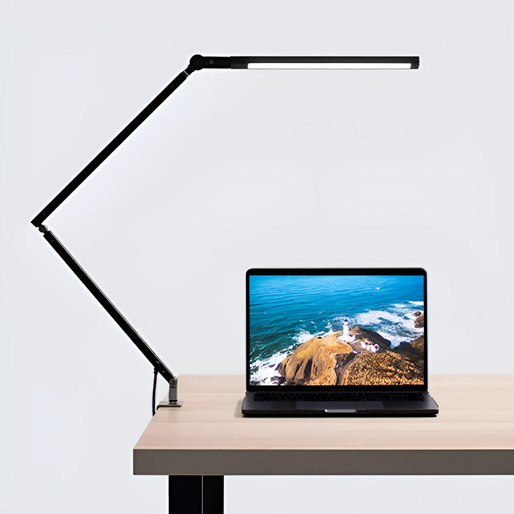 Aluminium LED desk lamp with a stainless steel clip mount and remote control on a wooden desk.