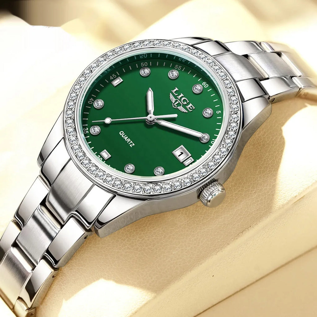 Silver stainless steel ladies watch with diamond bezel, luminous hands, and round 34mm dial.