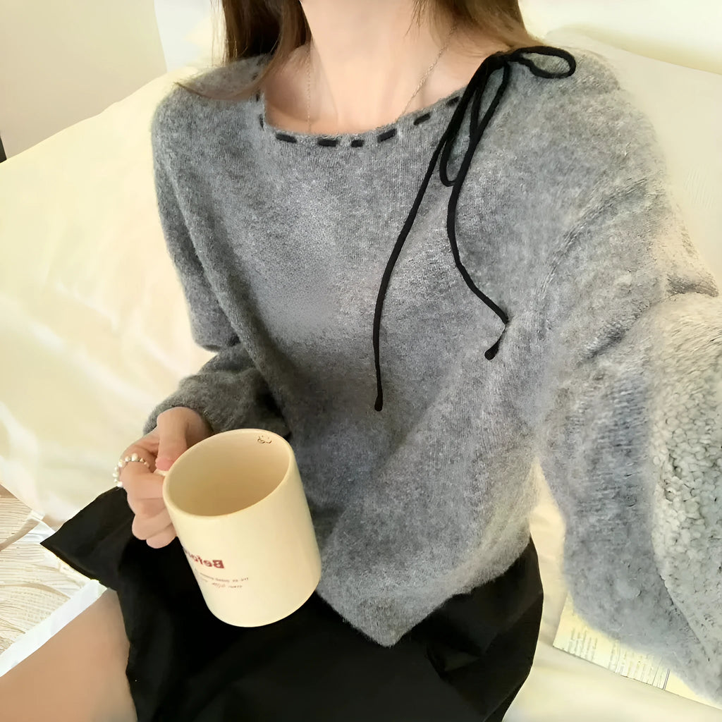 Grey loose-fitting women's knitwear pullover sweater on a hanger