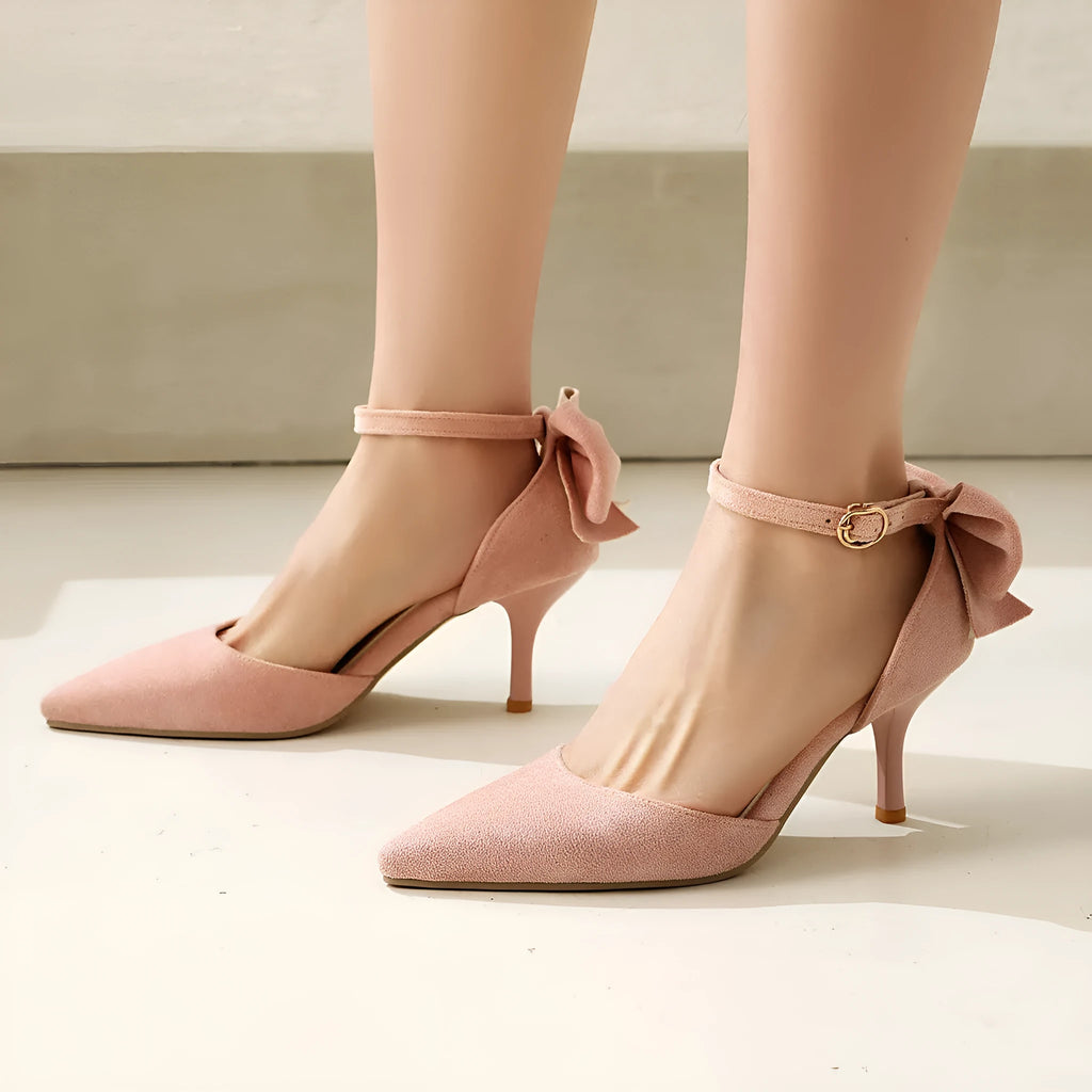 Women's pointed toe suede stiletto high heels with bowknot detail in black, pink, and beige