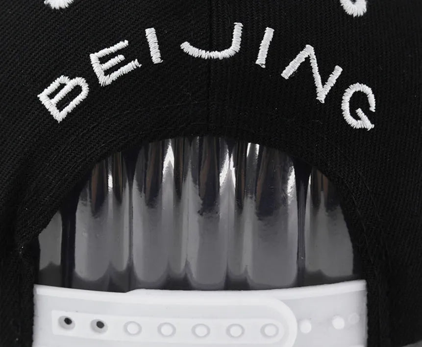 Cotton baseball cap with embroidered letters, adjustable sizing, in black or white colour