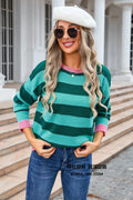 Women's loose blue striped acrylic long sleeve round neck sweater on a hanger