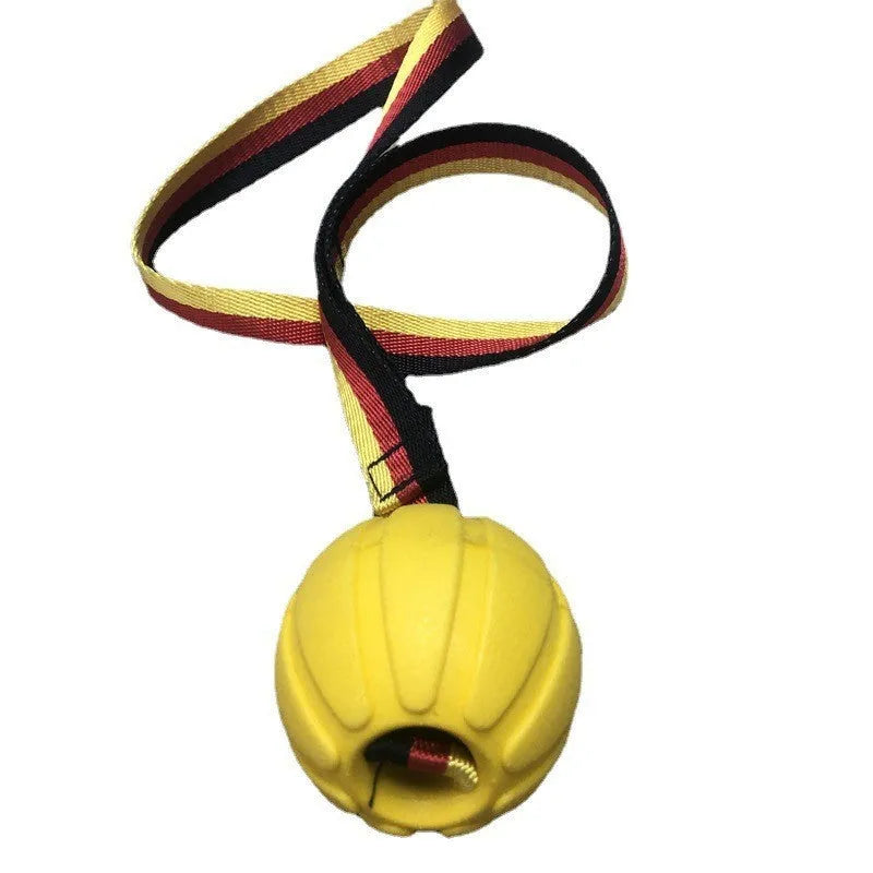 A floating EVA foam dog tetherball with a string attached, shown in camouflage colour next to a yellow one.
