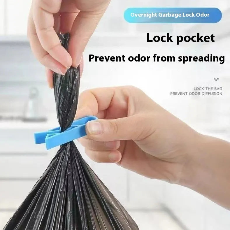 PP plastic bin bag fixing clip attached to a rubbish bin rim holding a liner in place.