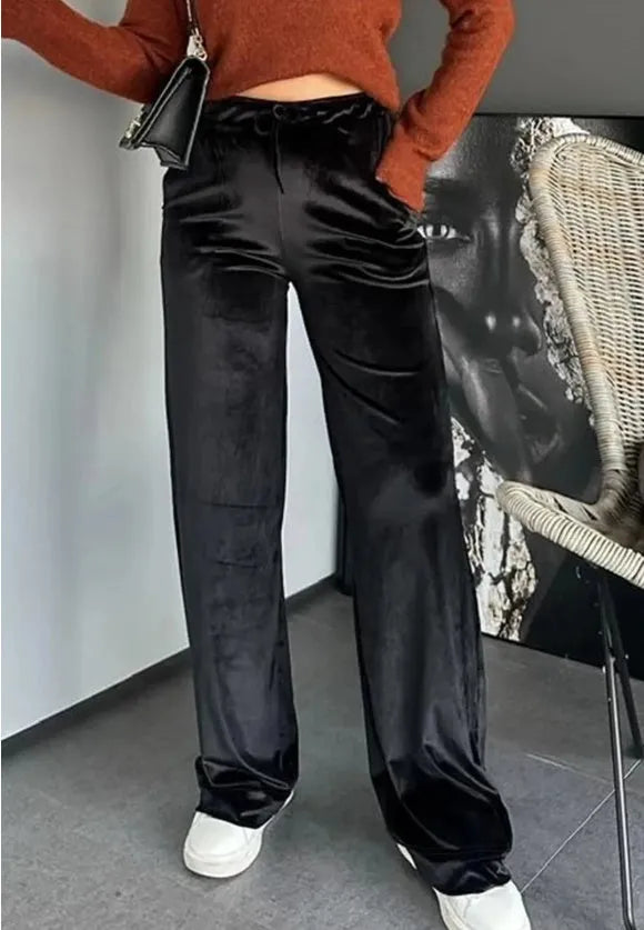 Black shiny velvet high waist drawstring straight leg casual pants on model showing full length
