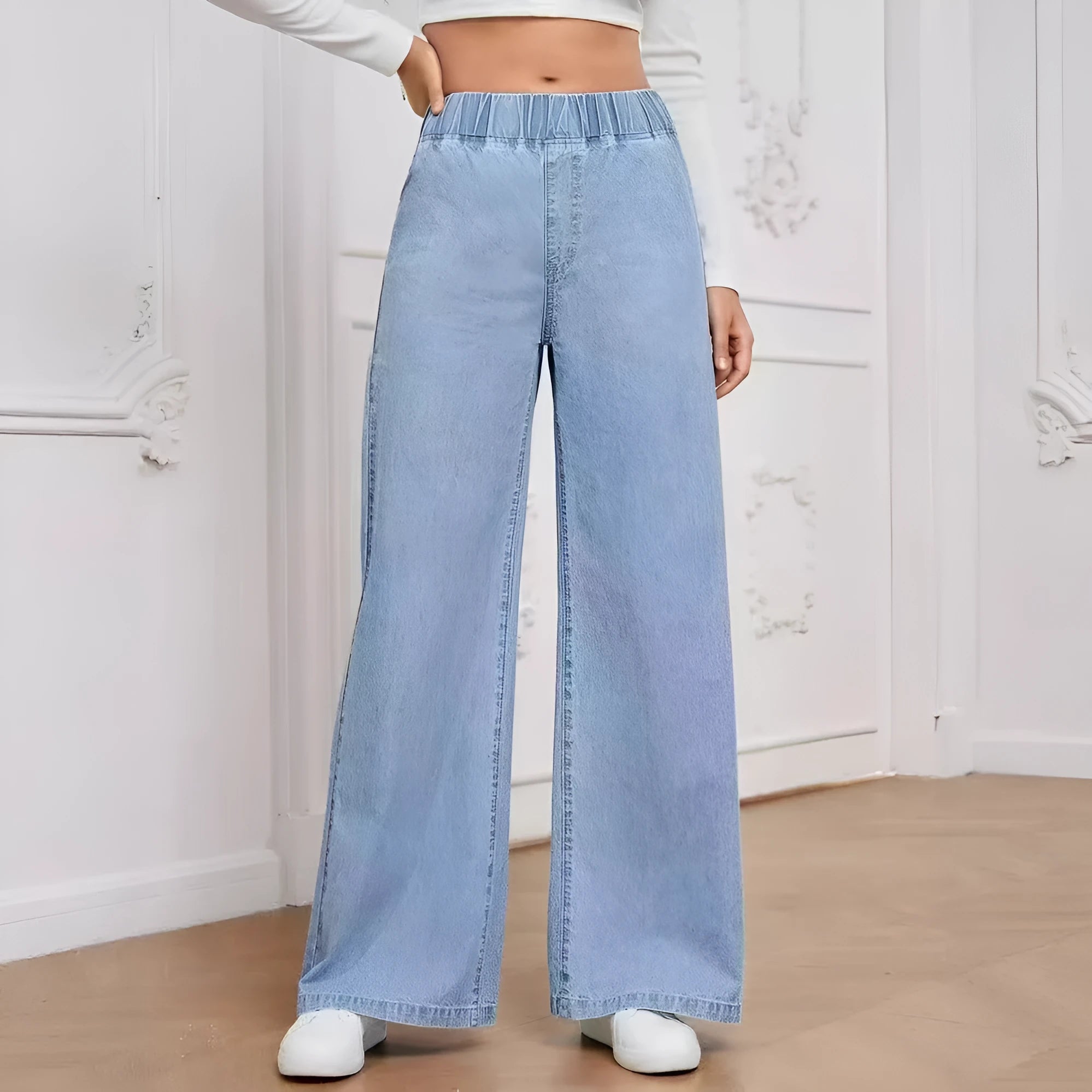 Light blue washed plus size wide-leg denim trousers laid flat showing straight leg silhouette