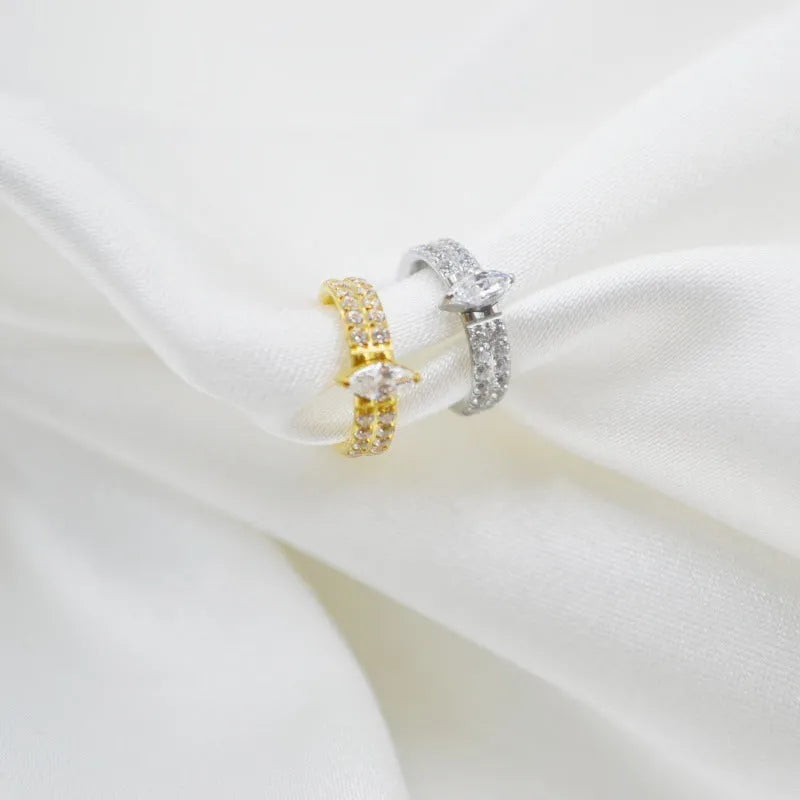 Close-up of a heart-shaped zirconia earring on a 316L steel post in silver tone.