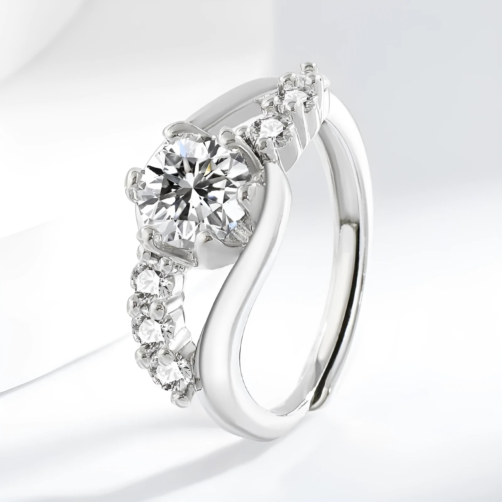White gold colour crown-shaped copper ring on a plain background