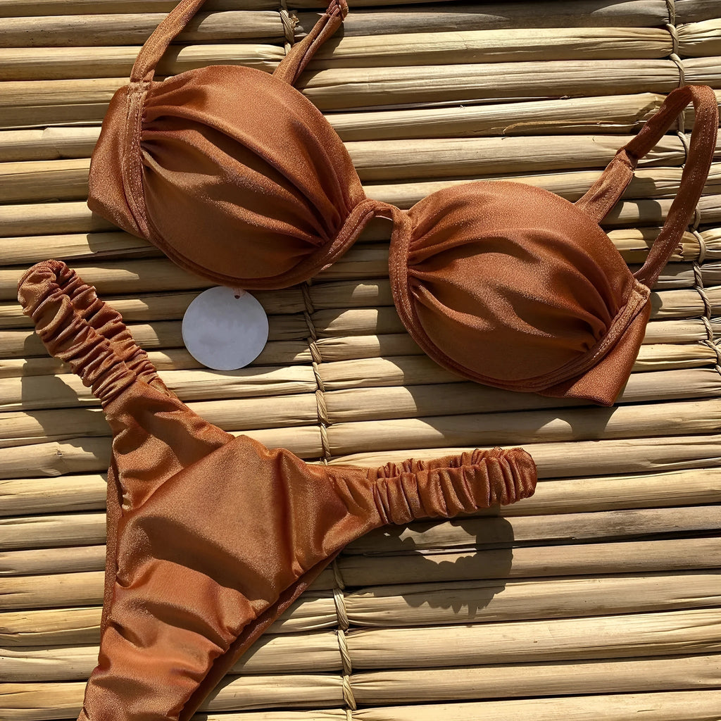 Women's black underwire bikini swimsuit with split briefs, shown on a model.