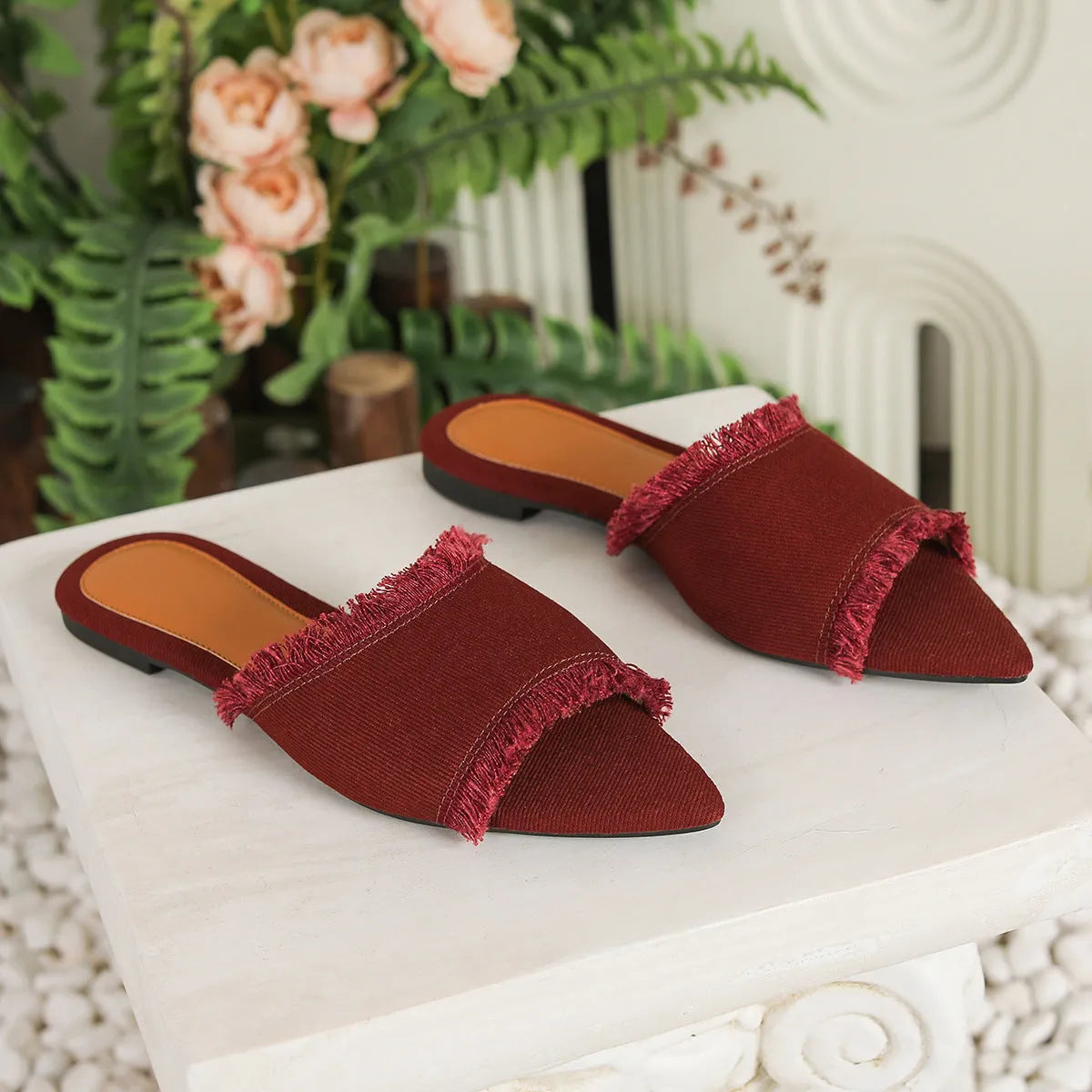 Women's casual denim flat slippers with a tassel detail and leather lining, shown in apricot colour.