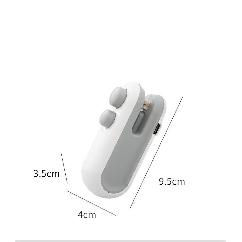 White handheld USB rechargeable heat sealer with cutter blade on a kitchen counter