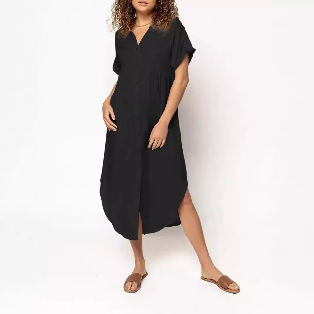 A loose-fitting, mid-length casual dress with a button-down front, shown in a solid colour.