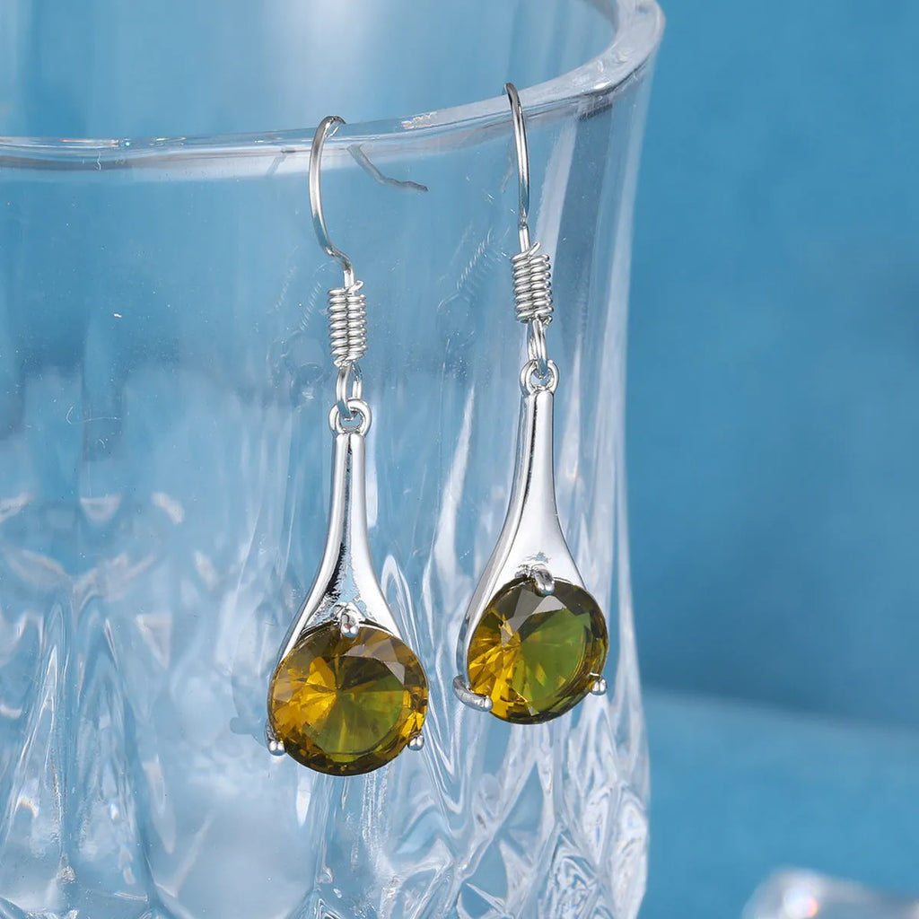 Olive green drop-shaped alloy earrings with posts on a white background.