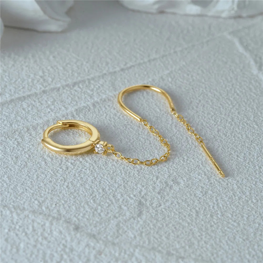 S925 sterling silver geometric drop earrings with flower, tassel, and chain details on an ear clip stud, in a golden tone.