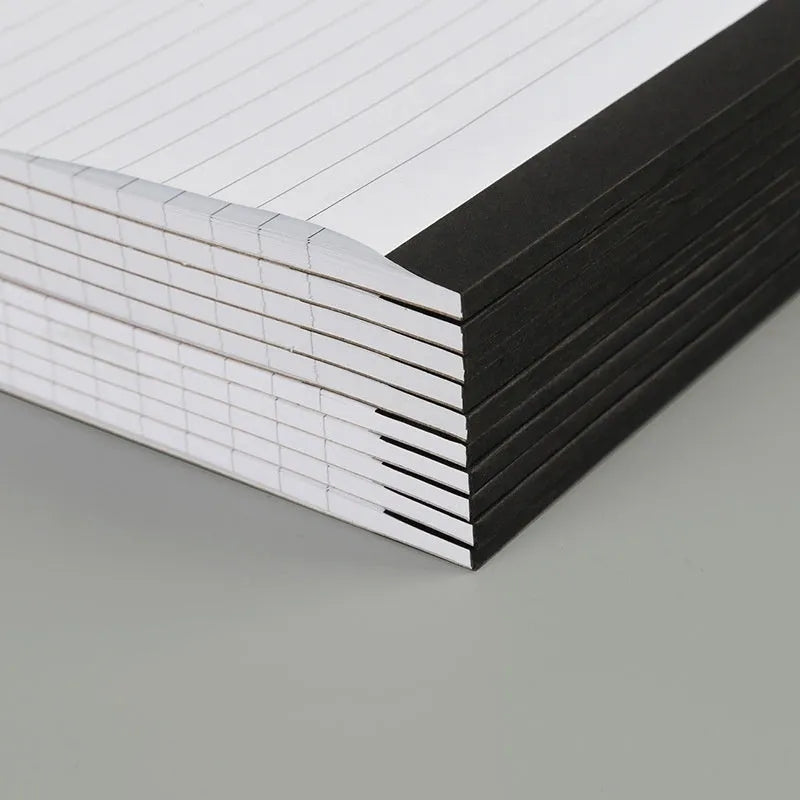 A4 tearable notebook with grid paper and a paper cover, shown open to reveal its pages.