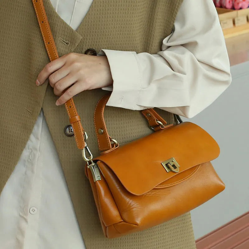 Women's retro genuine leather saddle handbag in black with visible stitching and double shoulder straps