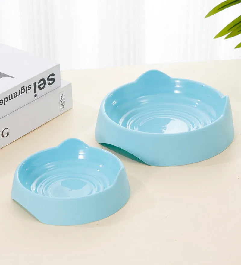 Blue ceramic dog slow feeder bowl with raised internal maze pattern for portion control