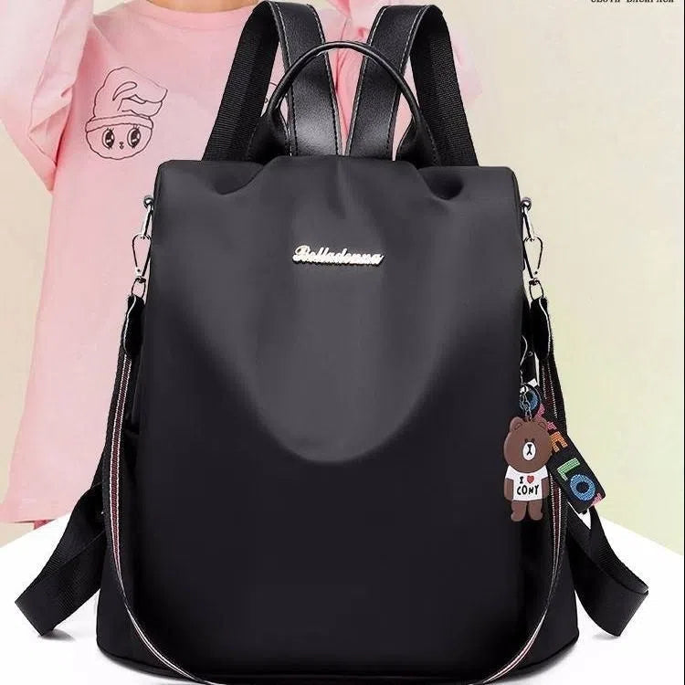 Women's large capacity black backpack with Oxford fabric lining, laptop sleeve, and trendy stitched seams and colour blocking