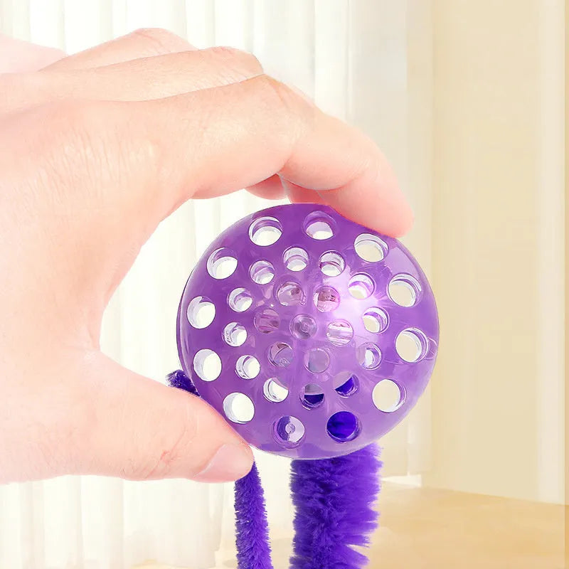 Interactive cat ball toy with worm tail in green on light background