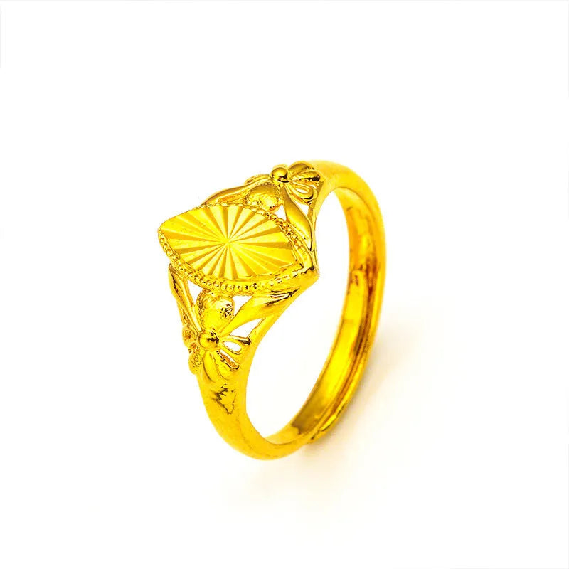 Open geometric flower ring in gold colour with textured details on brass base