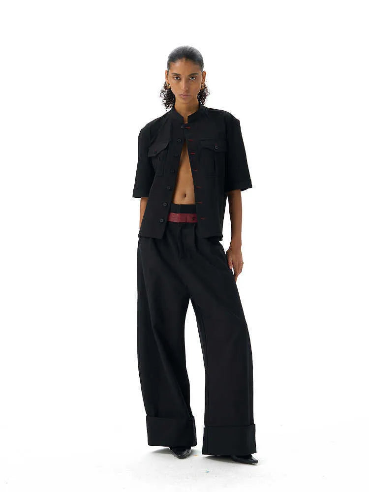 Black handmade half-sleeve hunting shirt with a shirt collar and loose fit on a mannequin.