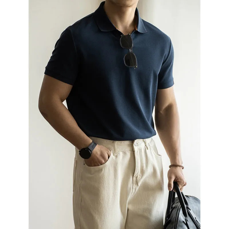 Men's short-sleeved blue polo shirt with a placket and collar, laid flat.