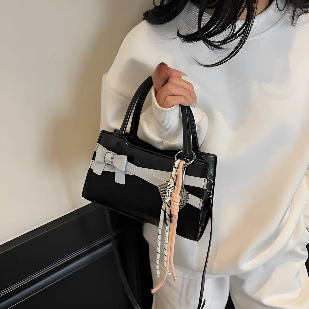 Soft nylon crossbody bag in urban simplicity, horizontal square shape, beige colour with flap pocket and stitching details.