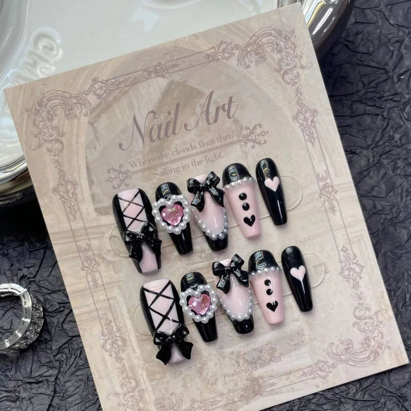 Black peach heart hand-painted artificial nails with cat's eye design in plastic storage case