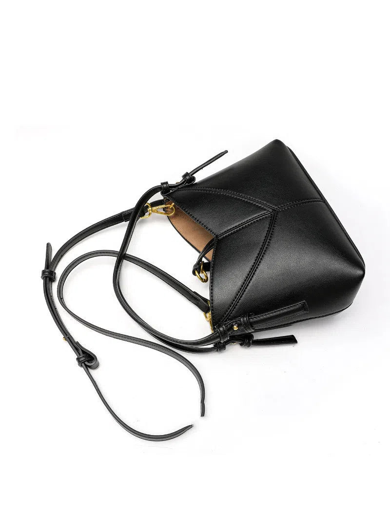 Trendy solid colour stitched oval handbag and crossbody bag for women in black with single shoulder strap and interior slip pocket